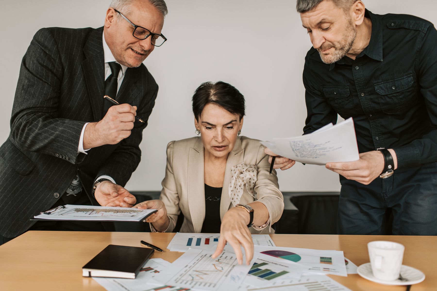 Professionals reviewing market reports and charts